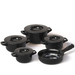 Set of black mini cookware pots on a white background